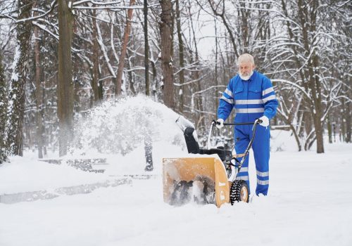 Man cleaning snow with snowblover